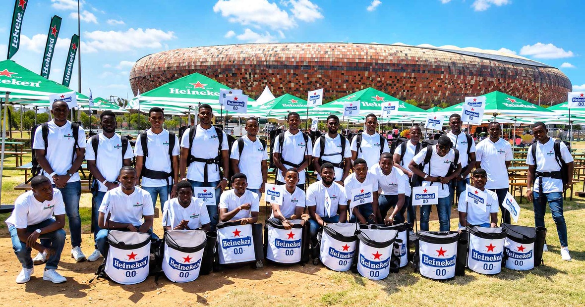Event beverage vendors with backpack drink dispensers at a large outdoor venue