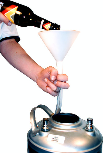 Filling a Rocketpacks stainless steel beverage tank through the container opening using a funnel